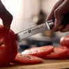 ZWILLING Four Star Utility knife 5 inch, serrated edge Sleek, polypropylene handles are crafted with a minimum amount of 75% recycled plastics.