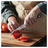 ZWILLING Pro 5-inch Utility Knife, Serrated Edge Designed to be an extension of your hand encouraging cutting with improved precision, safety and comfort.